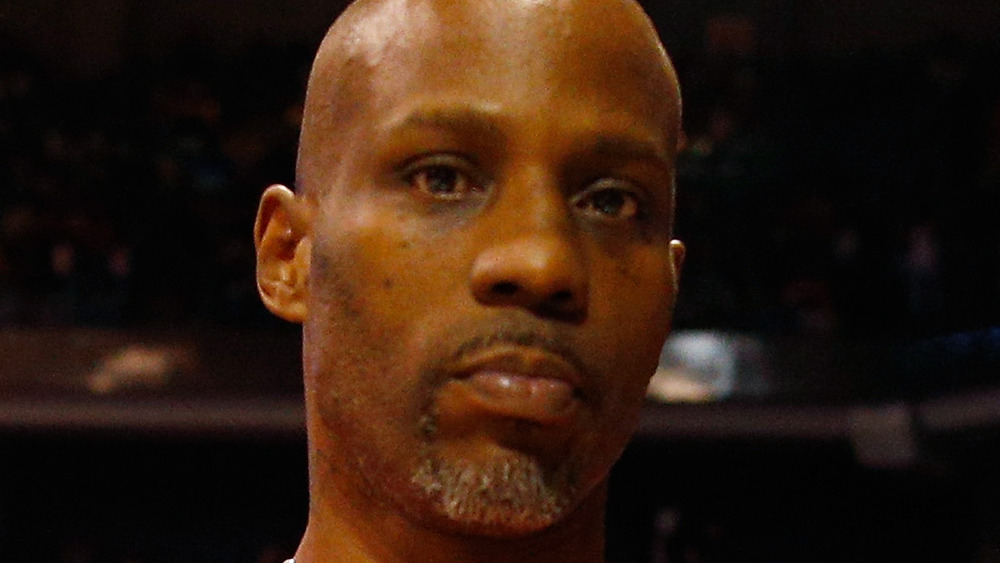 DMX poses on the courtside for the camera at a game