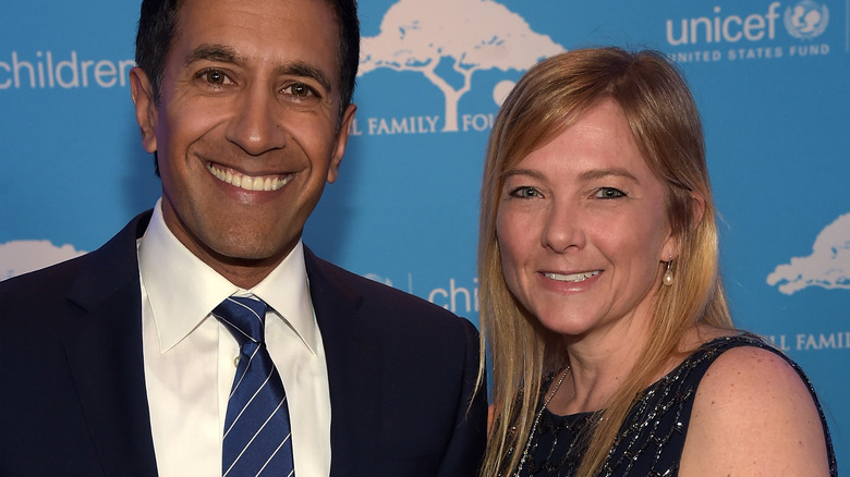 Dr. Sanjay Gupta and Rebecca Olson Gupta smiling on red carpet