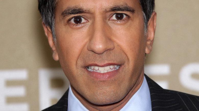 Dr. Sanjay Gupta smiling on red carpet 