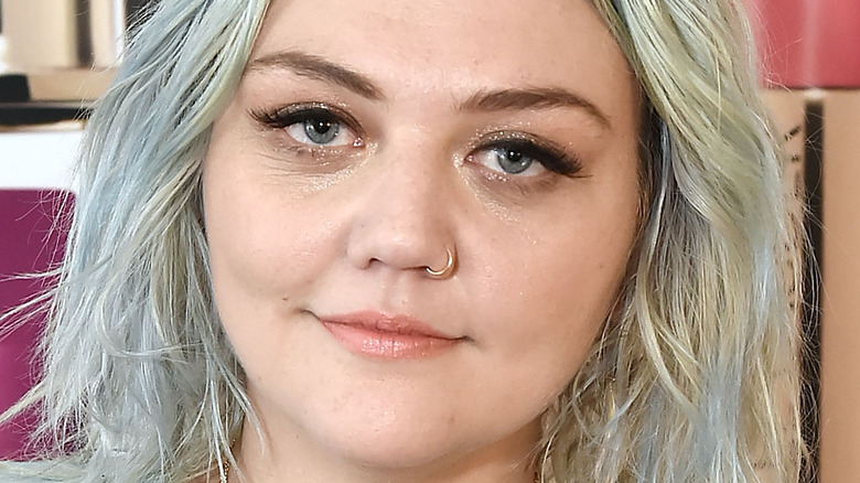 Elle King gives a slight smile at an event