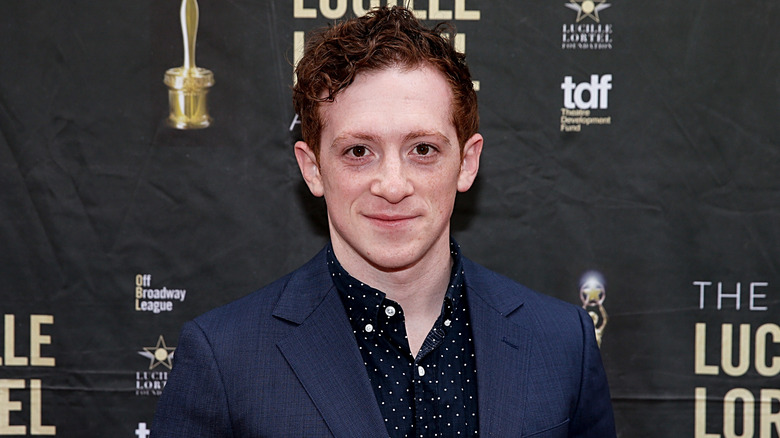 Ethan Slater smirking