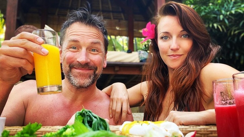 Paul Greene holding juice beside Kate Austin