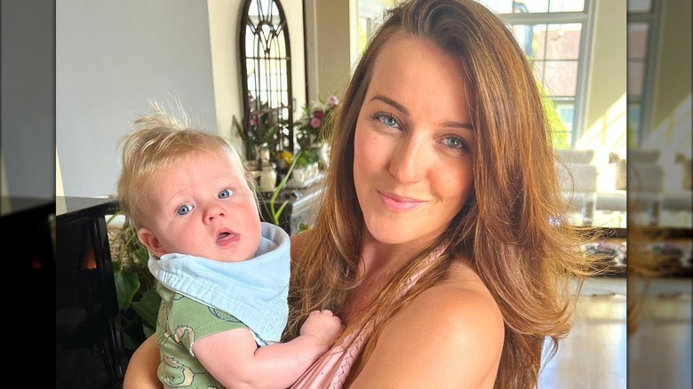 Kate Austin holding son