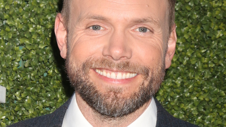 Joel Mchale smiling with beard