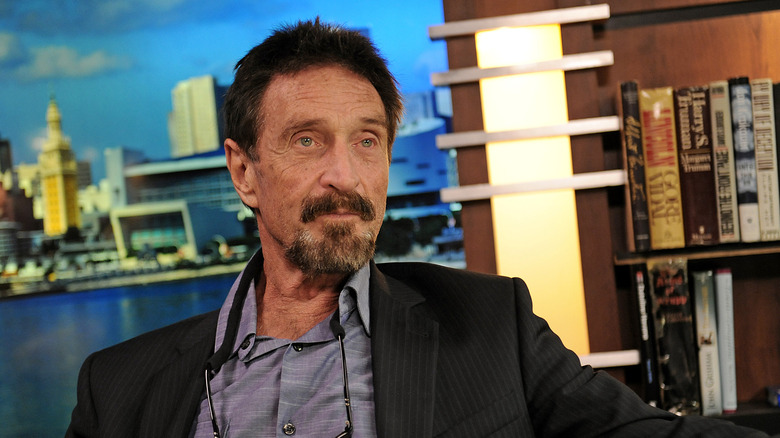 John McAfee looking to the side during 2012 interview