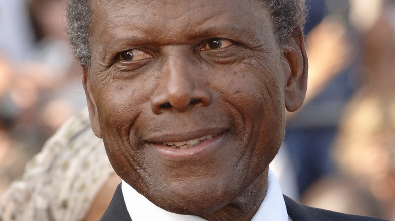Sidney Poitier smiling back to the right
