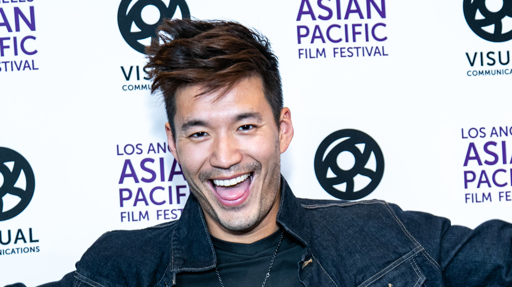 Kevin Kreider posing at step and repeat