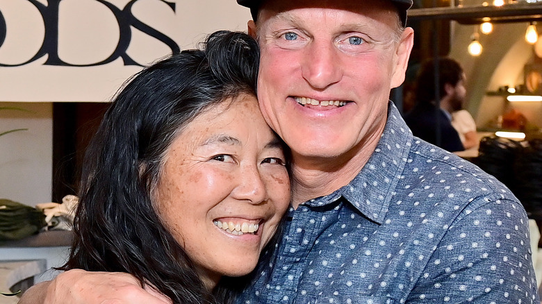 Woody Harrelson embracing Laura Louie