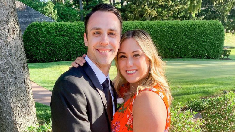 Matt Moeller and Alaina Scott pose at a wedding celebration