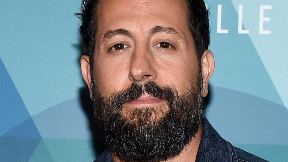 Matthew Ramsey smiles on the red carpet at an award show