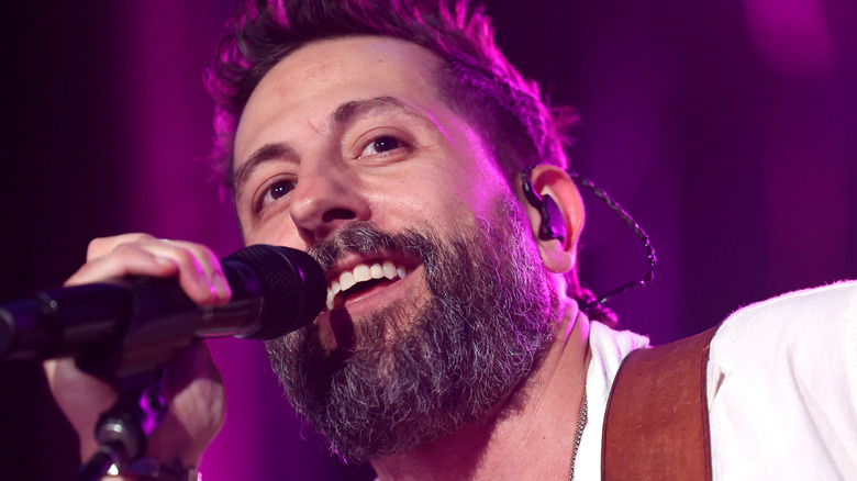 Matthew Ramsey singing into mic