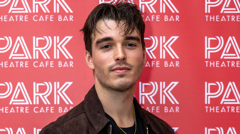 Corey Mylchreest wearing brown suede jacket
