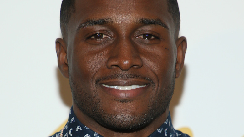 Reggie Bush smiles in a blue dress shirt