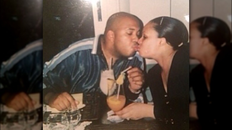 Rev Run and Justine Simmons kissing in a throwback photo