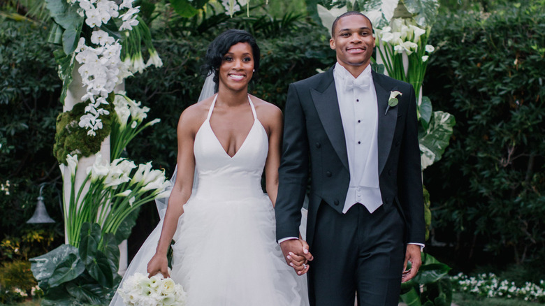 Nina and Russell Westbrook walking on their wedding day