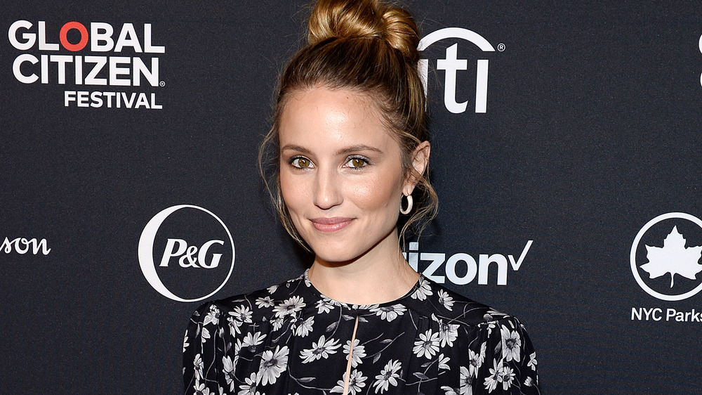Dianna Agron smiling on a red carpet
