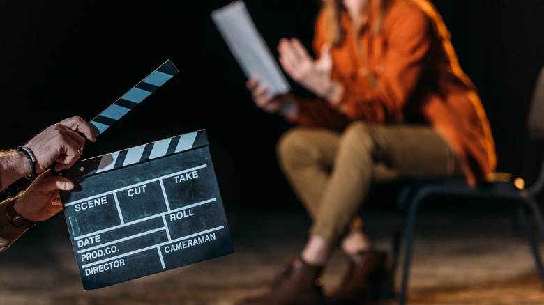 Clapboard with actor rehearsing