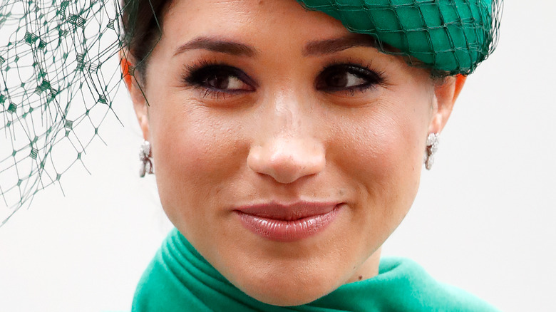 Meghan Markle poses in a green outfit