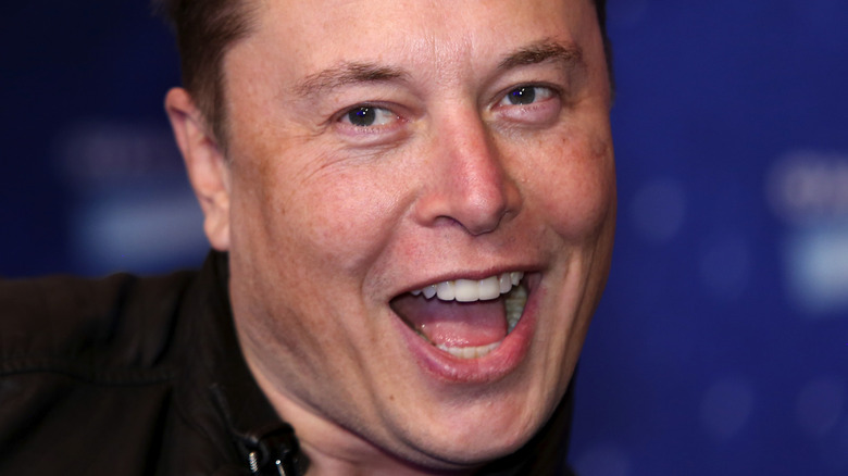 Elon Musk laughing clean shaven