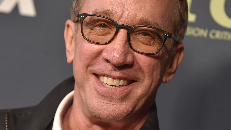 Tim Allen smiling and wearing glasses