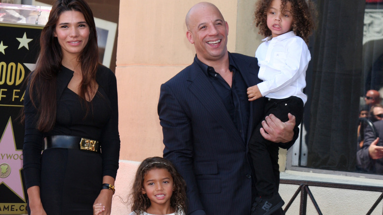 Paloma Jimenez and Vin Diesel pose at an event with their children