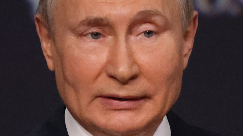 Vladimir Putin, speaking during a 2021 speech, looking older, no facial hair