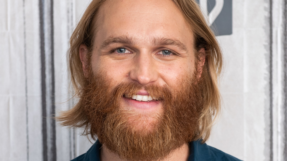 Wyatt Russell smiles for the cameras at a photo call
