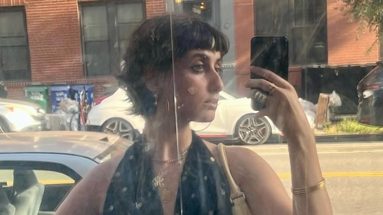 Reflection of Rama Duwaji taking a selfie