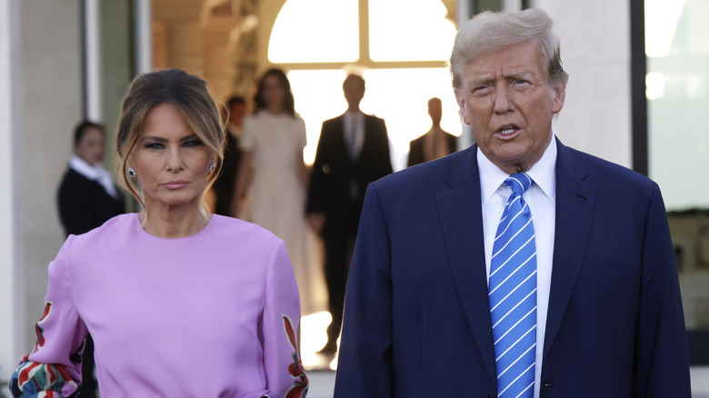 Melania Trump scowls as she stands next to Donald Trump