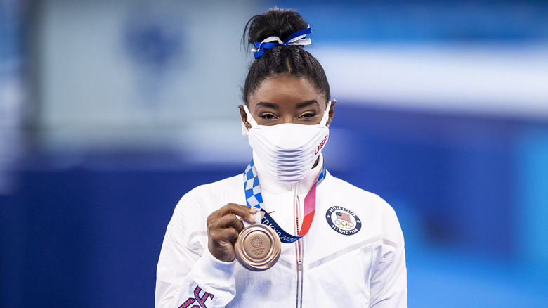 Simone Biles with her bronze medal