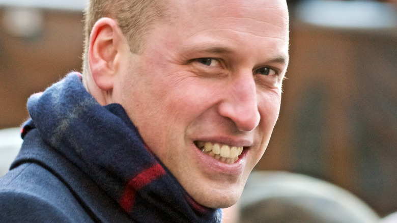 Prince William smiling and wearing scarf