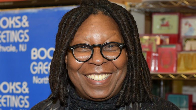 Whoopi Goldberg smiles at a book signing
