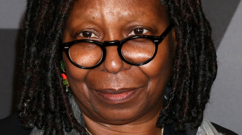 Whoopi Goldberg wearing black glasses