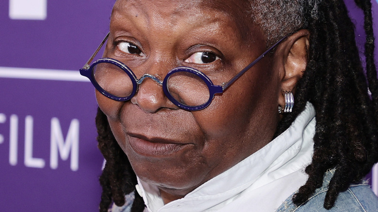 Whoopi Goldberg looking over glasses