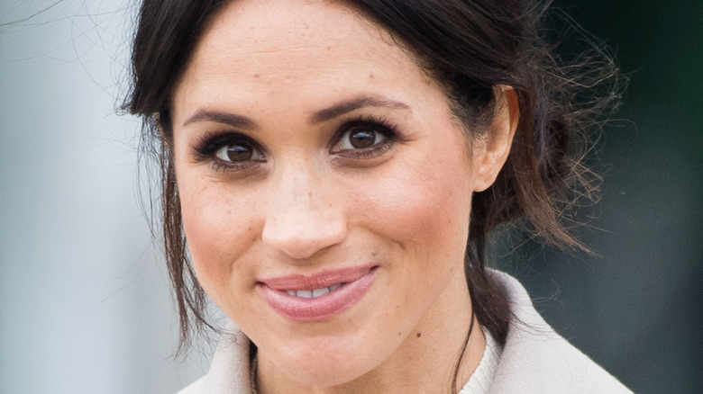 Meghan Markle smiles at an outing