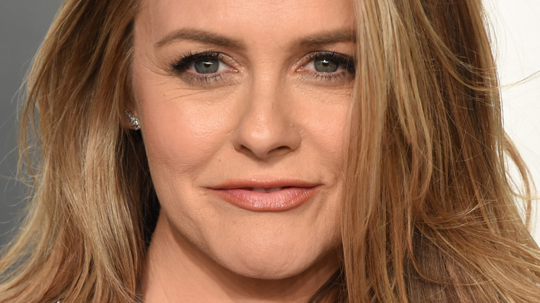 Alicia Silverstone smiling on the red carpet