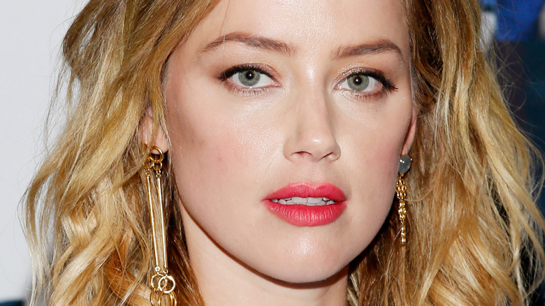 Amber Heard looking serious red lip 