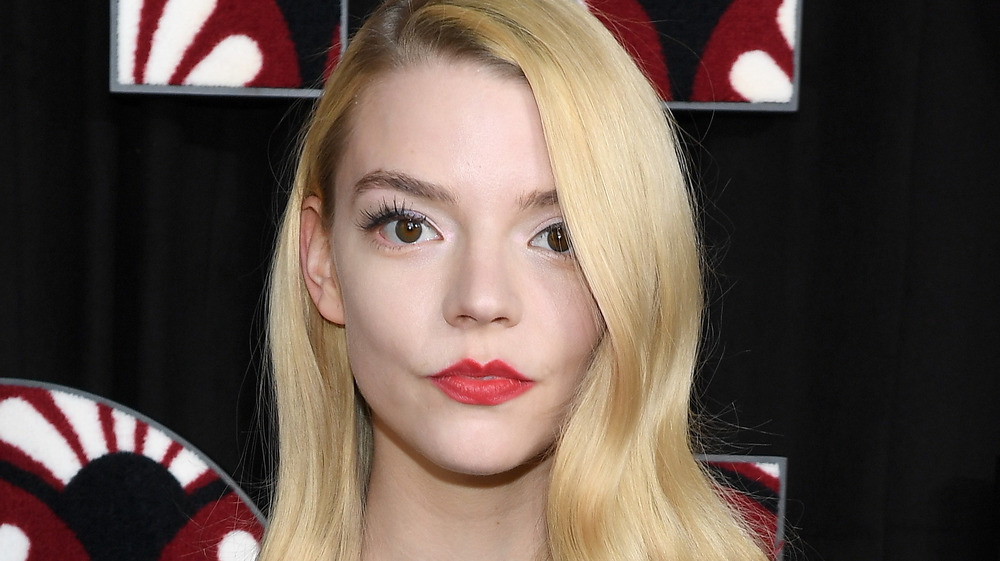 Anya Taylor-Joy wearing red lipstick at an event