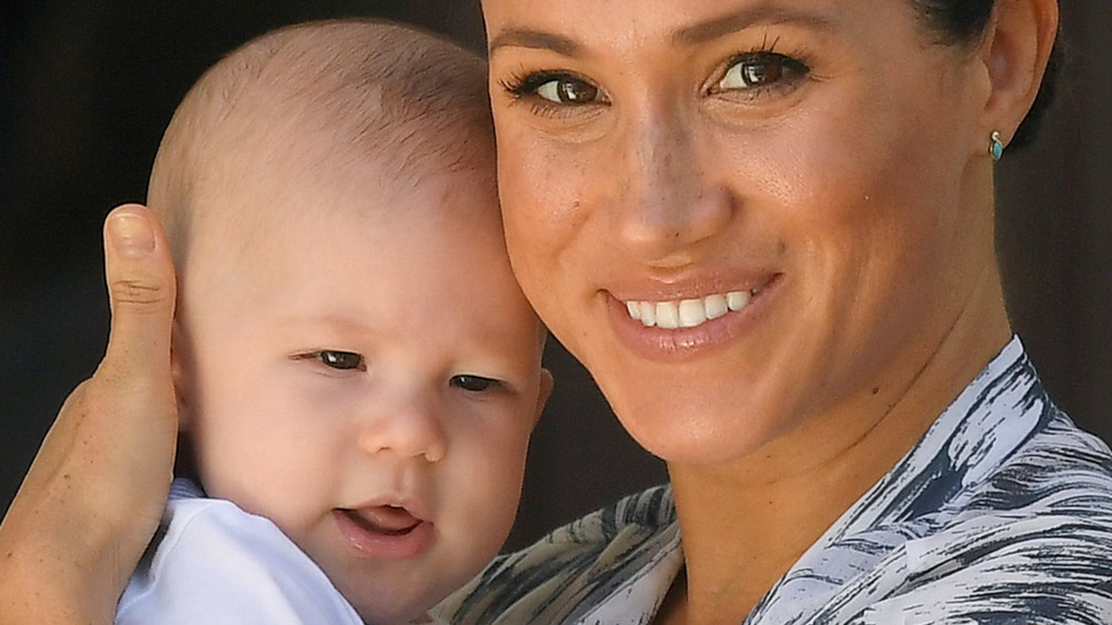 Archie and mom Meghan Markle smiling