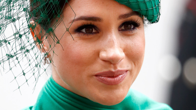 Meghan Markle, the Duchess of Sussex, wearing fascinator with slight smile