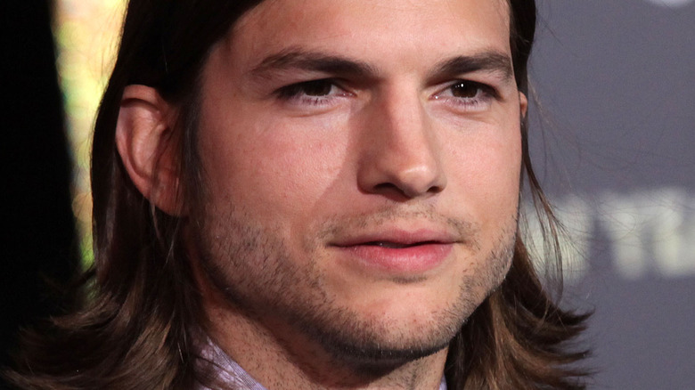Ashton Kutcher with serious expression on the red carpet