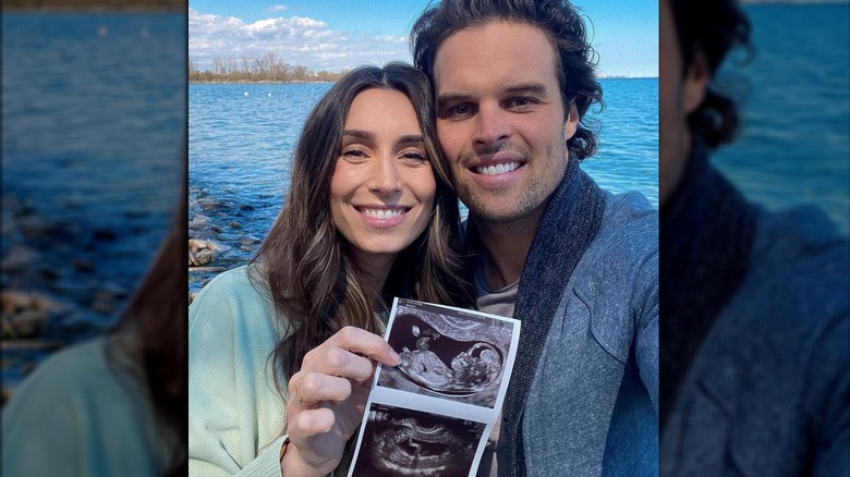 Astrid Loc and Kevin Wendt pose for a selfie with their sonogram 