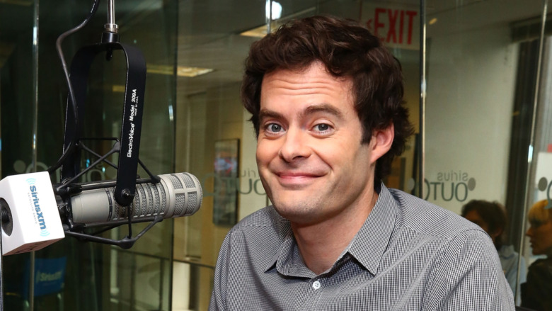 Bill Hader sitting next to microphone