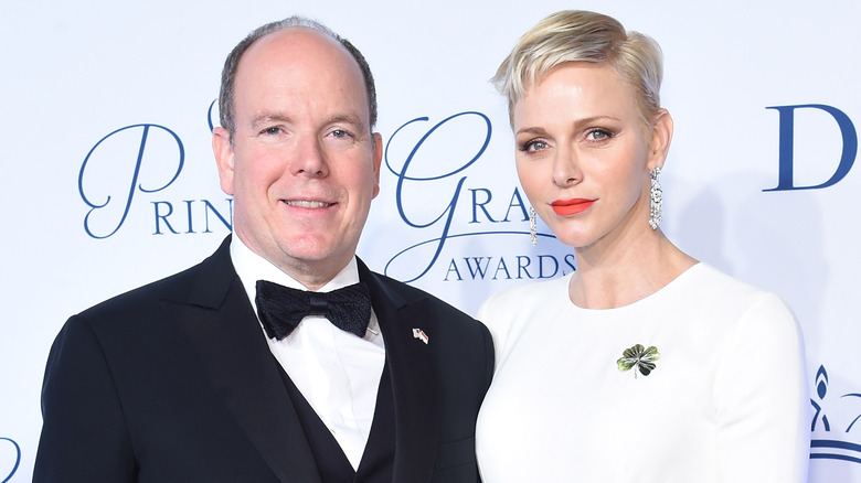 Prince Albert smiling, Princess Charlene short blonde hair