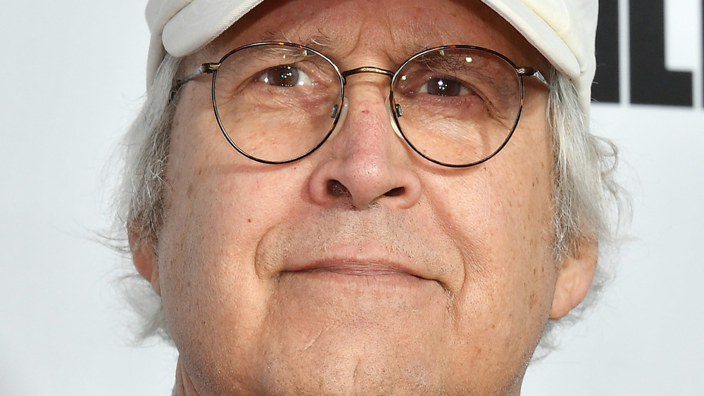 Chevy Chase smiling at a red carpet event