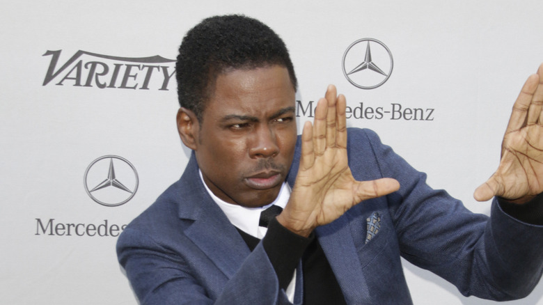 Chris Rock posing with hands up