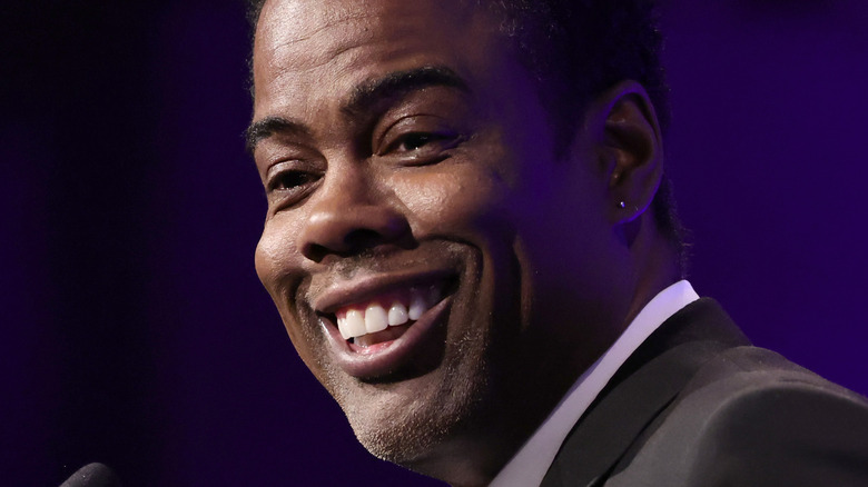 Chris Rock on stage smiling