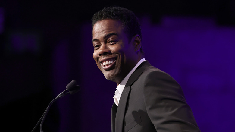 Chris Rock on stage smiling
