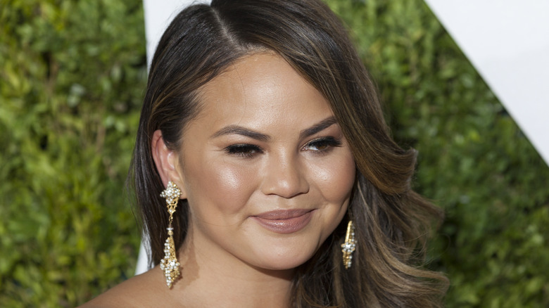 Chrissy Teigen poses at an event