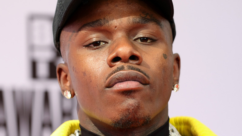 DaBaby wearing a black hat